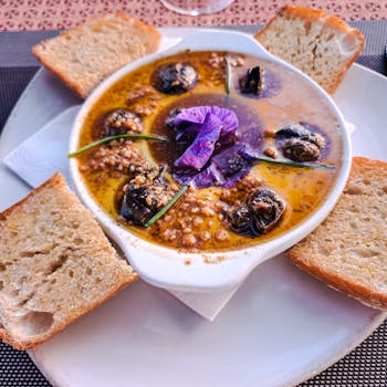 Escargot with edible flower garnish