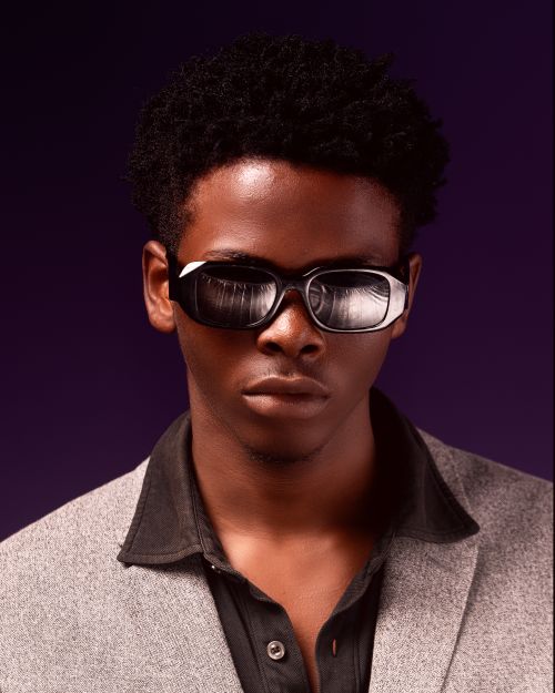 Free Sharp portrait of a man in sunglasses and a suit against a dark background. Stock Photo