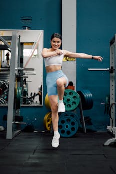 Energetic woman performing exercises in a gym, showcasing fitness and strength.