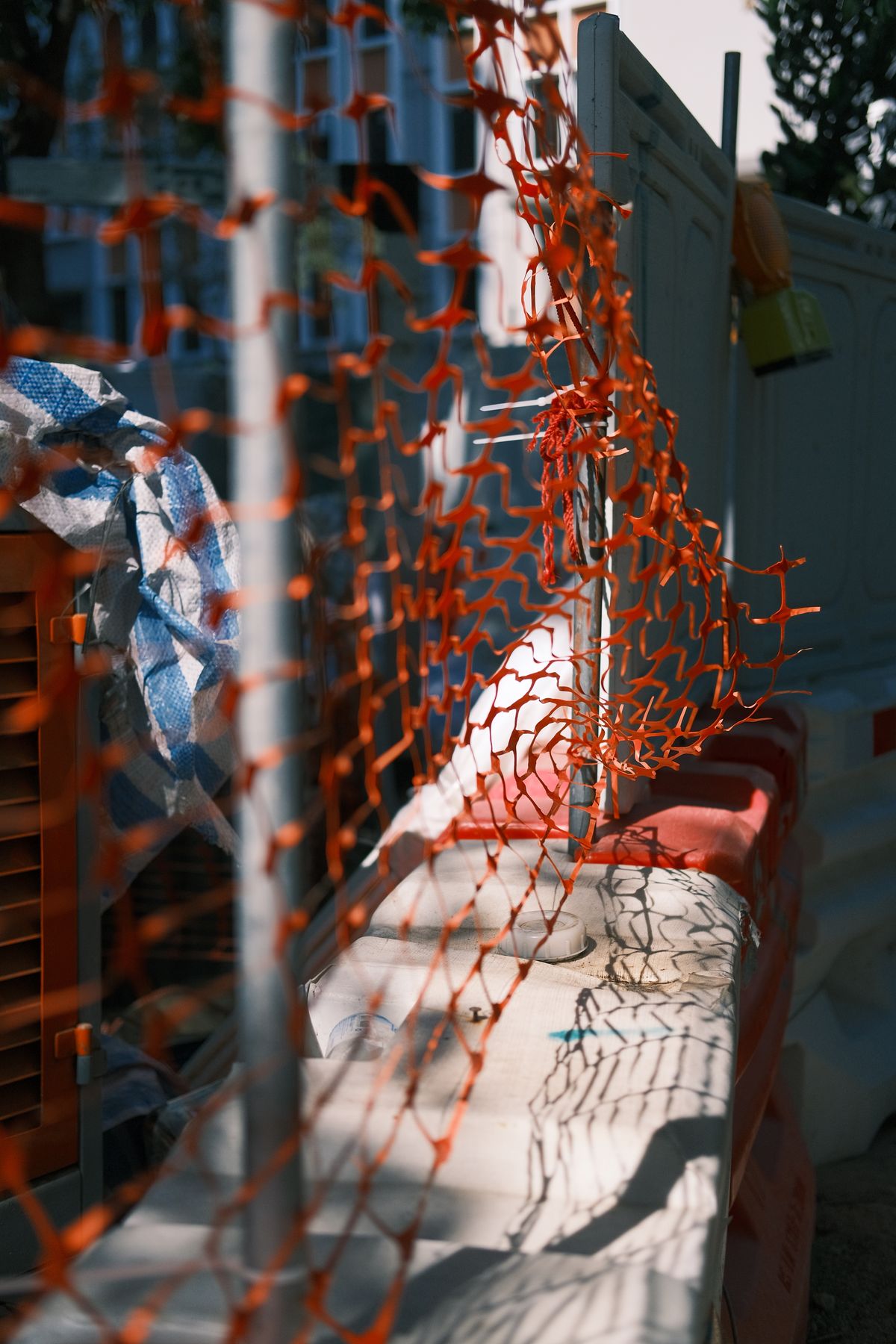 Temporary construction fence around a downtown Hamilton build on the LRT corridor