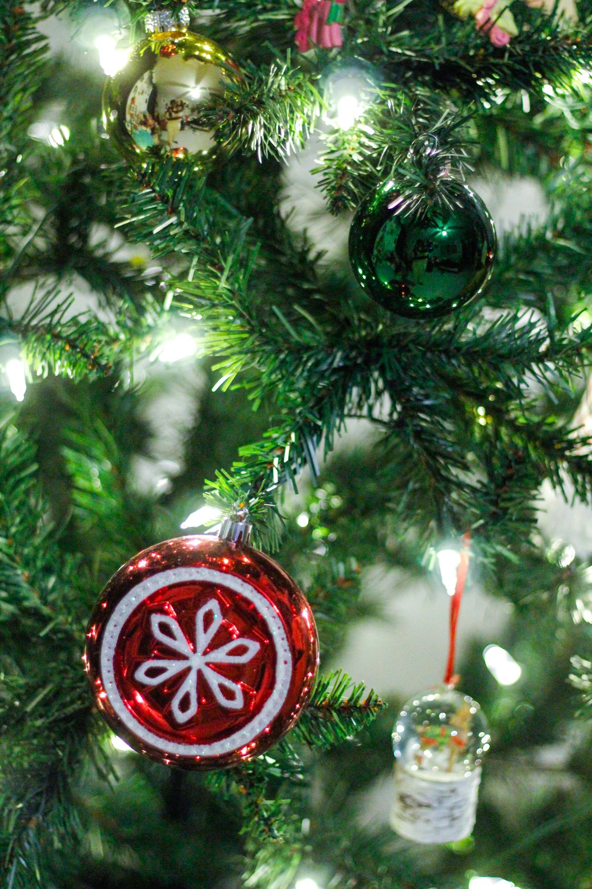 Colourful Christmas tree with mixed ornaments and warm lights