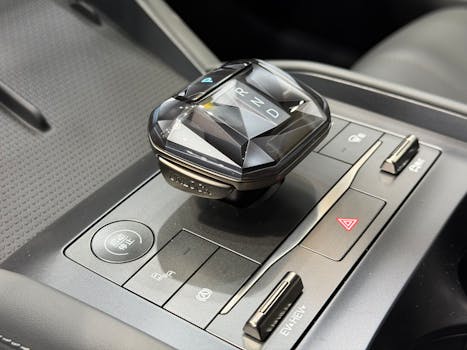 Close-up of a car's sophisticated gear shift with a sleek, modern design.