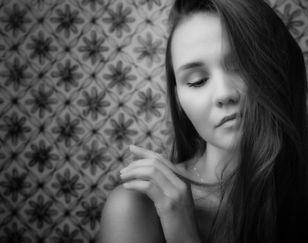 A serene black and white portrait of a woman with closed eyes and flowing hair.