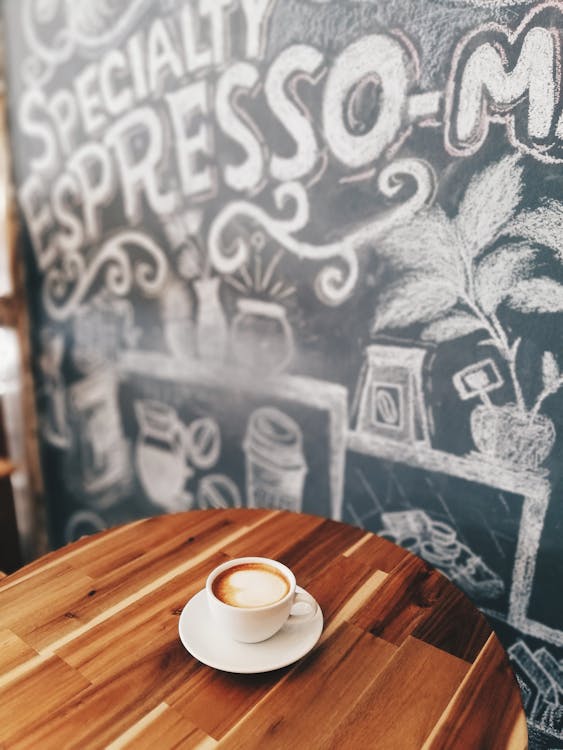 Free White Ceramic Mug on White Saucer on Brown Wooden Table Stock Photo