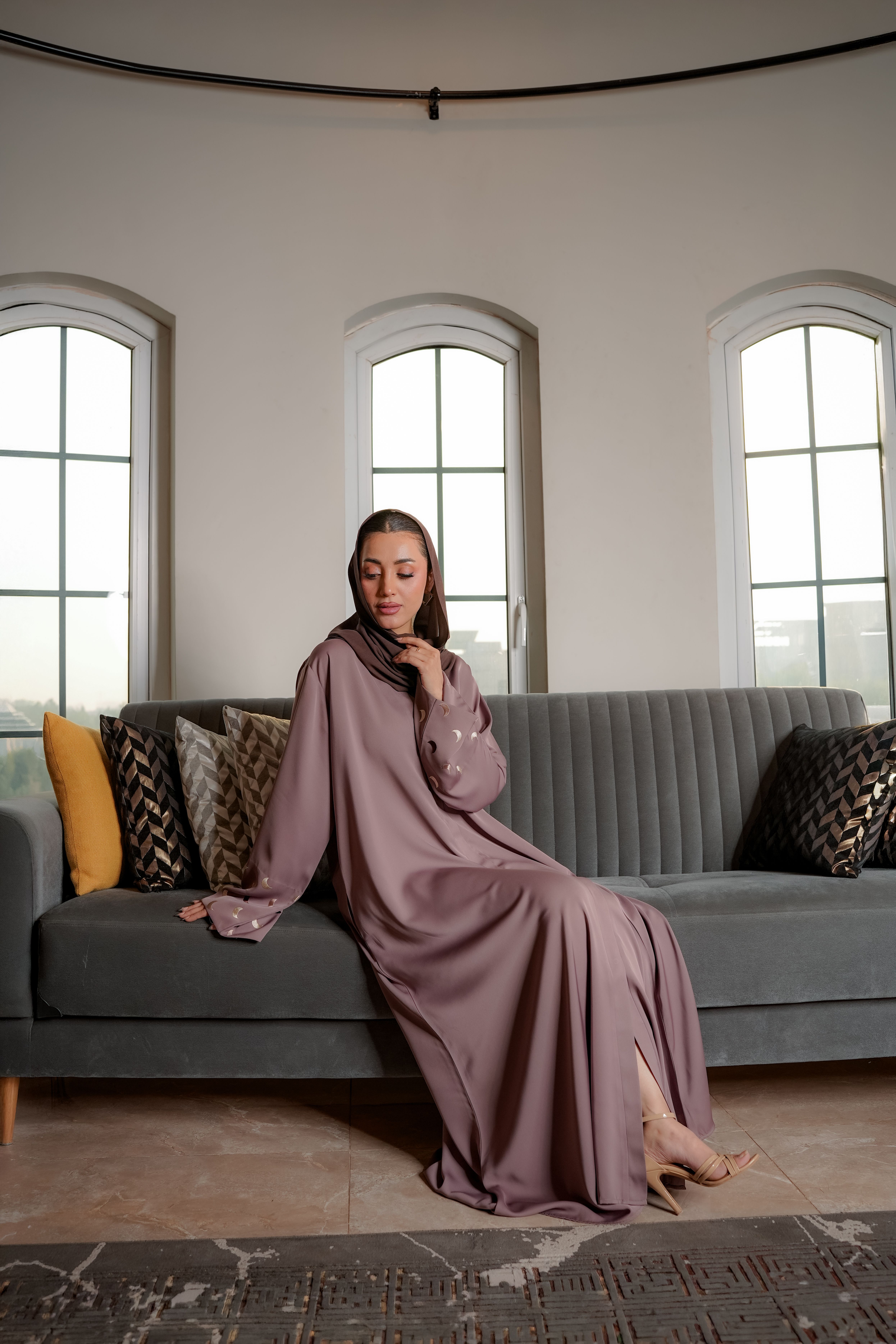 Elegant Woman in Modest Clothing Sitting Indoors · Free Stock Photo
