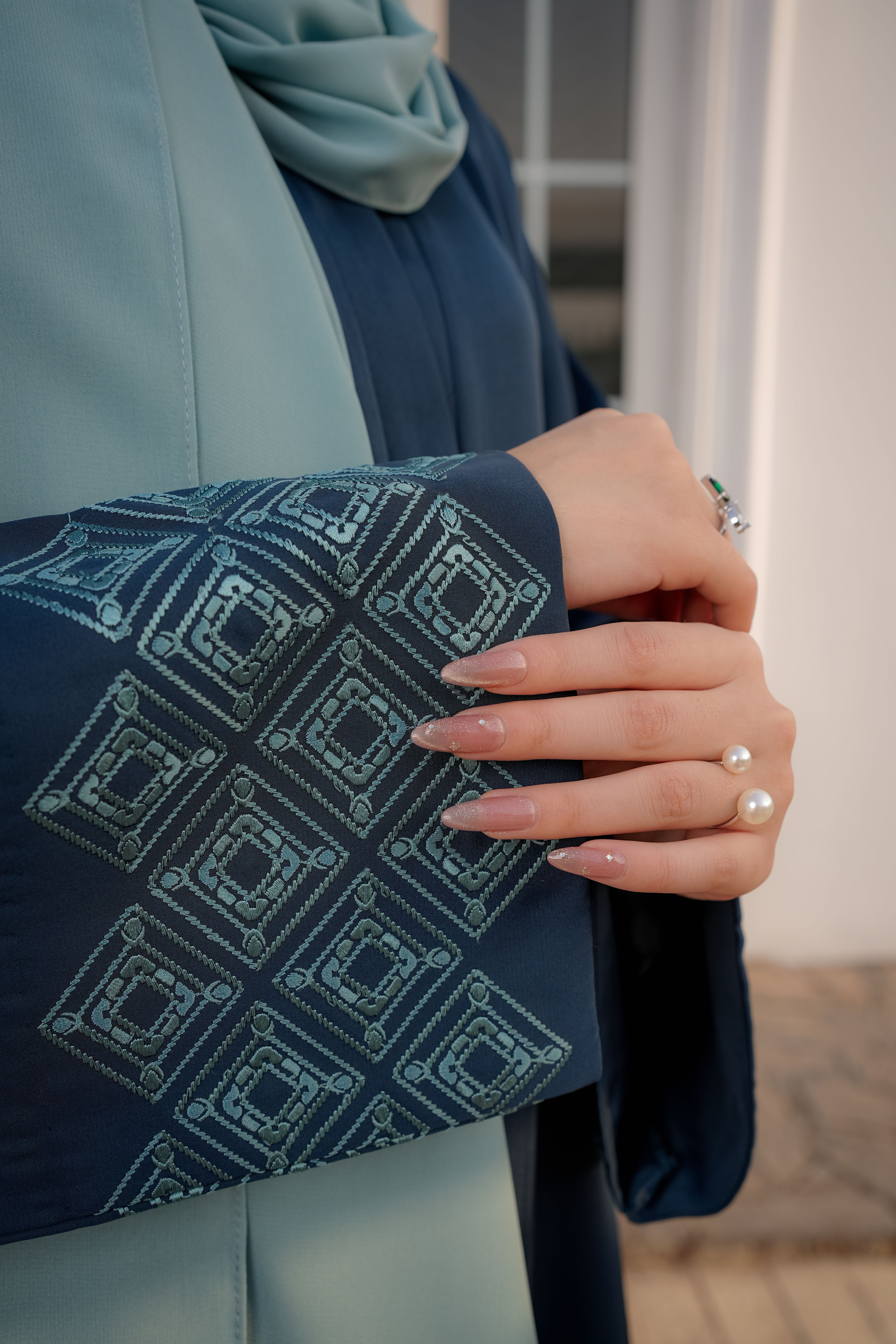 Elegant Hand in Modest Blue Attire with Geometric Patterns · Free Stock ...