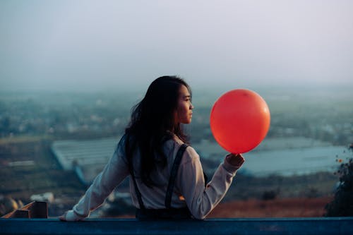 Free Woman Wearing White Dress Shirt While Holding Red Balloon Stock Photo