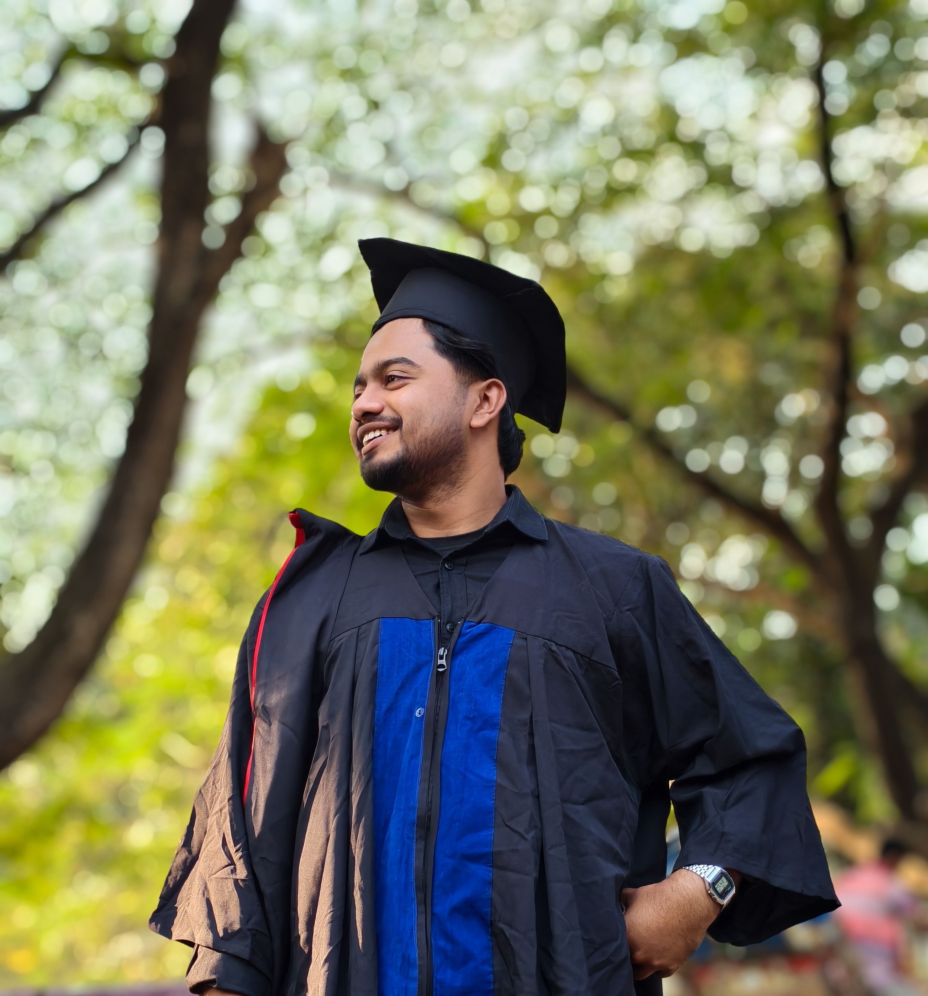 Happy Graduate Smiling Outdoors in Cap and Gown · Free Stock Photo