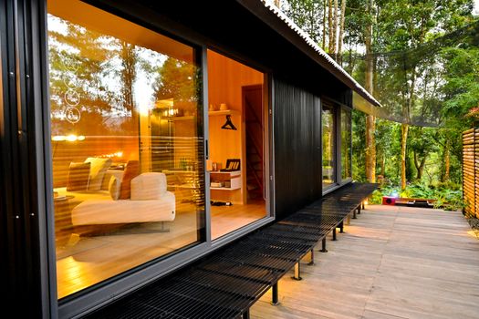 Modern cabin with warm interior and forest view in Java, Indonesia. Perfect for relaxation and nature retreats.