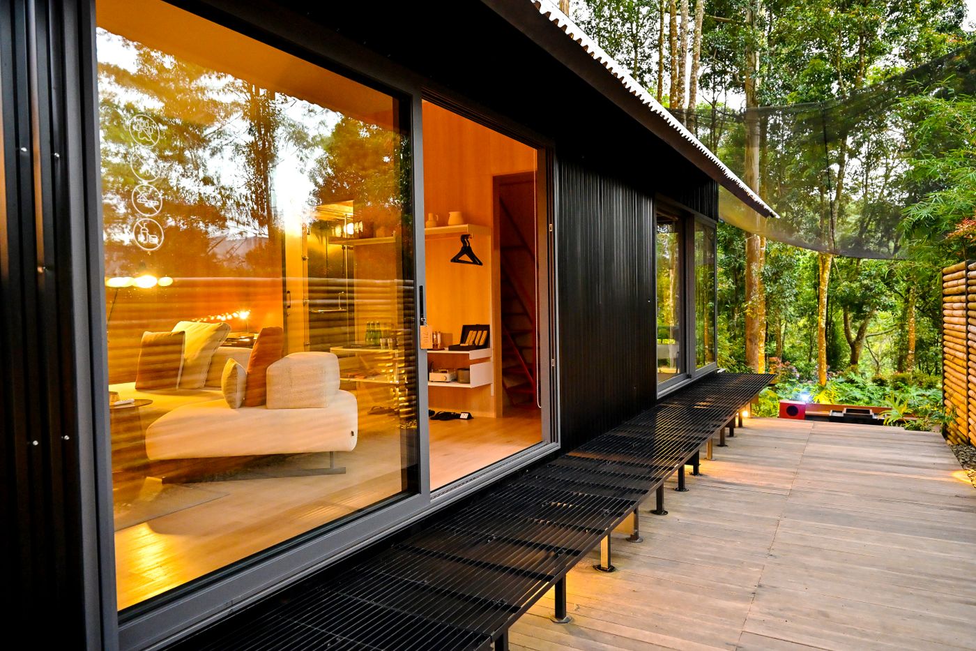 Dark-clad garden studio with lit interior and timber deck — photo by kevin yung on Pexels