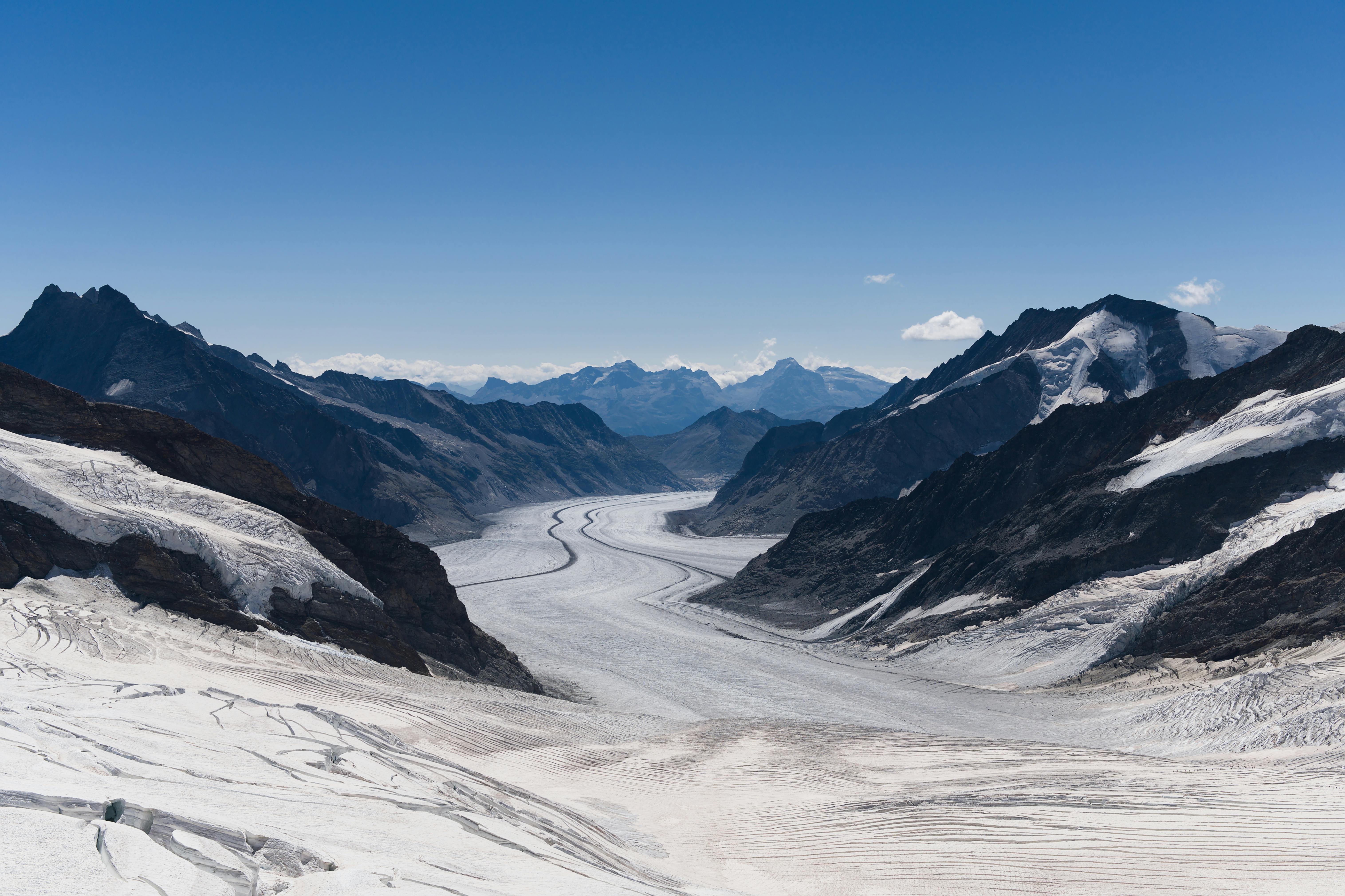 Panoramic view of the Aletsch Glacier framed by majestic Swiss Alpine peaks -- the largest glacier in the Alps