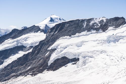 Free Breathtaking panoramic view of the snowy and rugged Jungfrau mountain peaks in Switzerland. Stock Photo