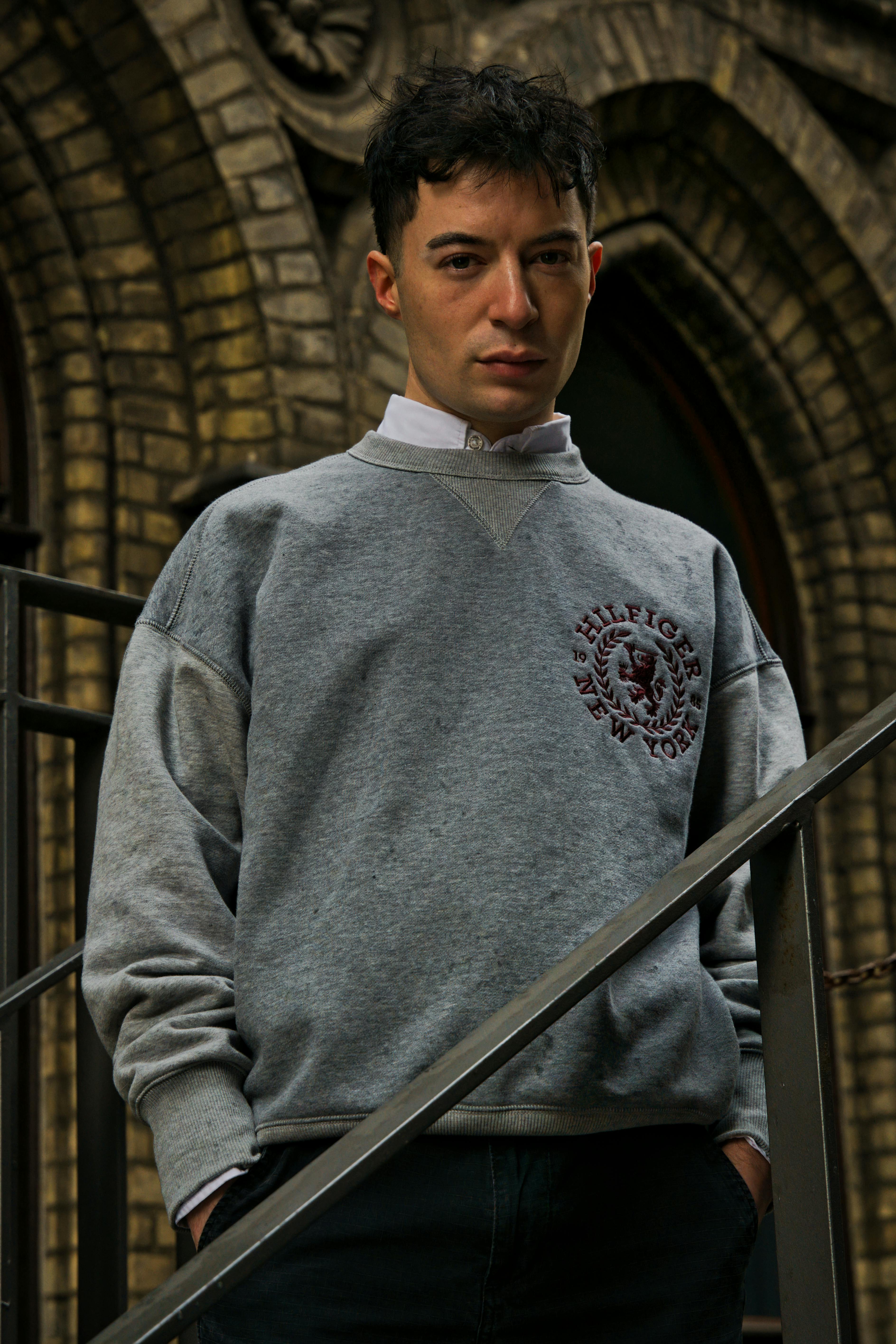 Casual portrait of a young man outdoors in Bremen with architectural background.