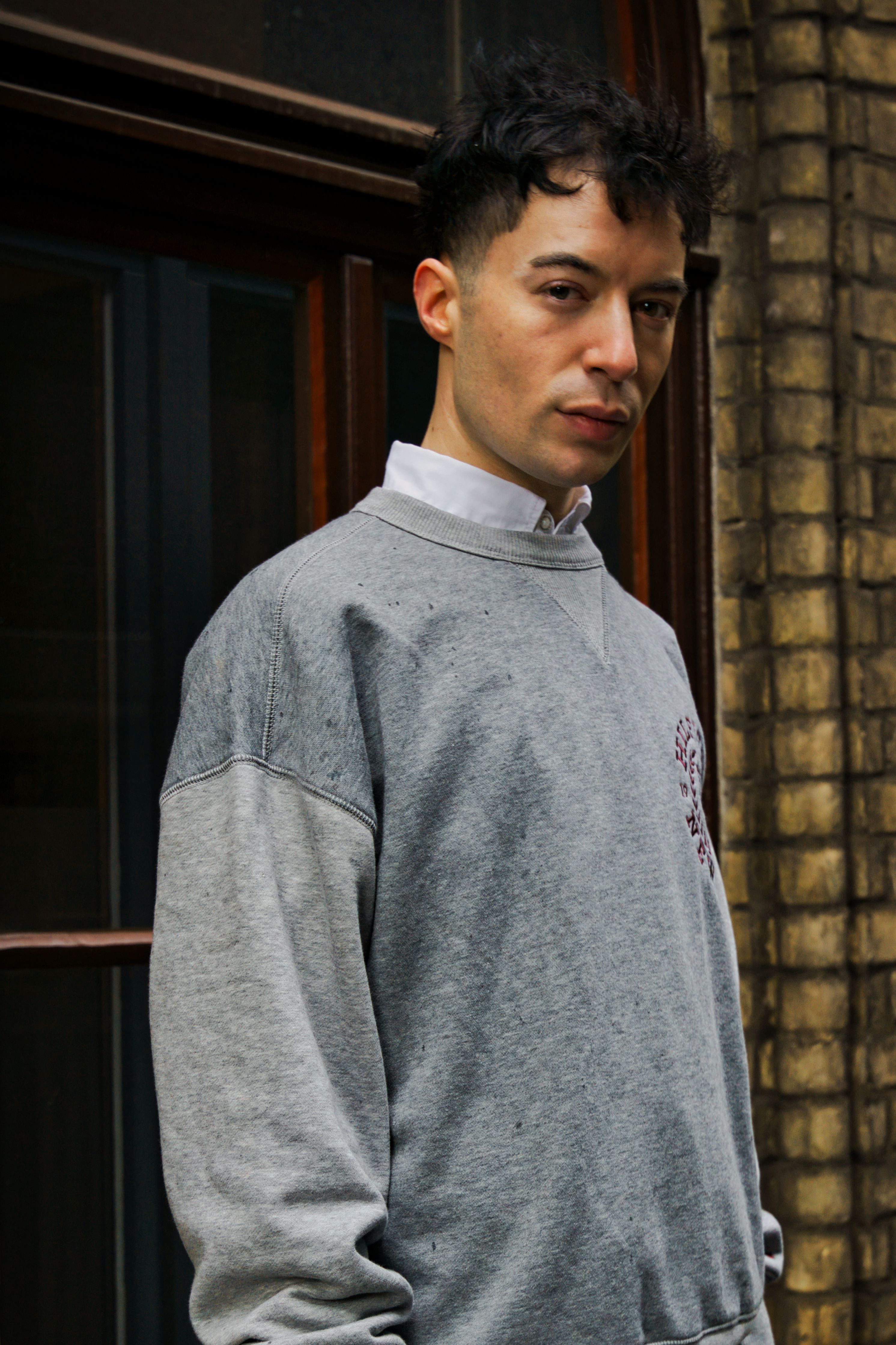Portrait of a man in casual attire, standing outdoors in Bremen, Germany.