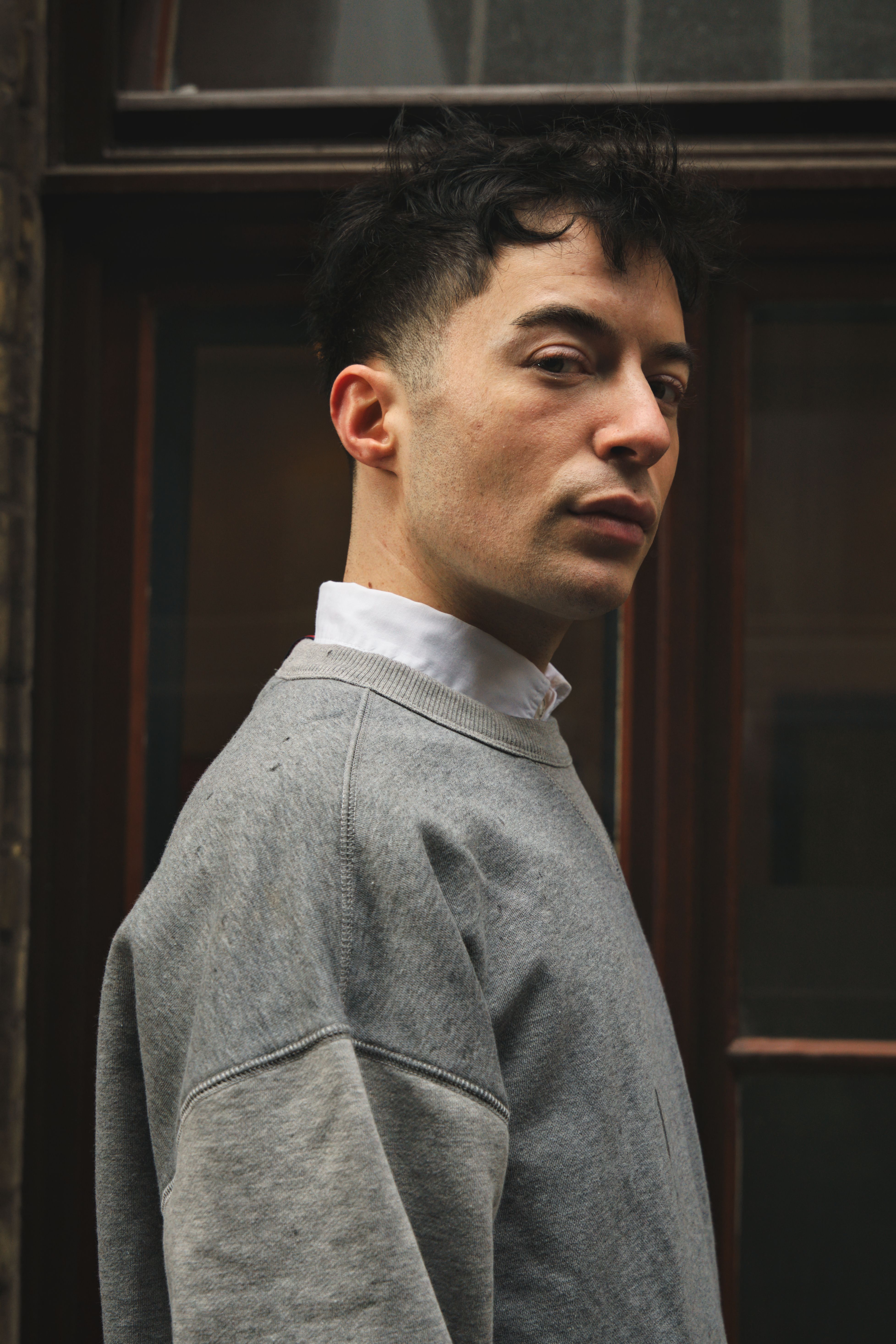 Portrait of a young adult in a casual outfit, captured in urban Bremen, Germany.