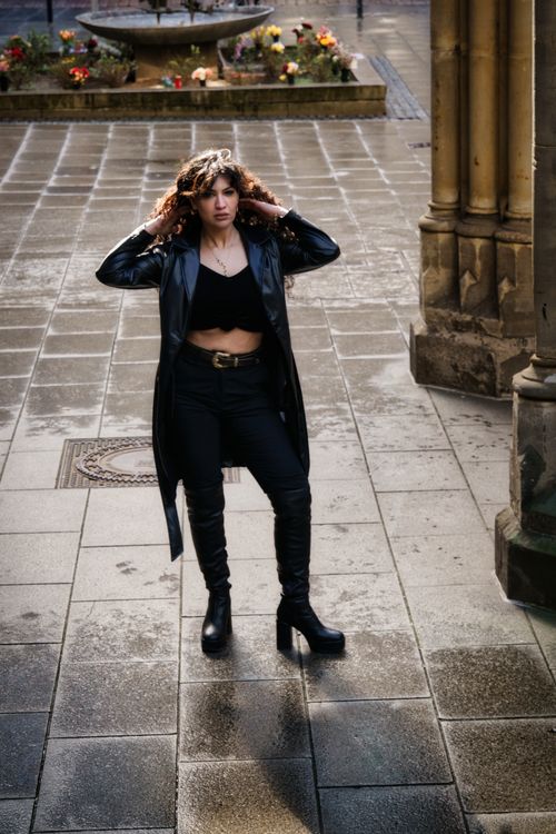 Stylish Woman in Black Coat on Urban Street · Free Stock Photo