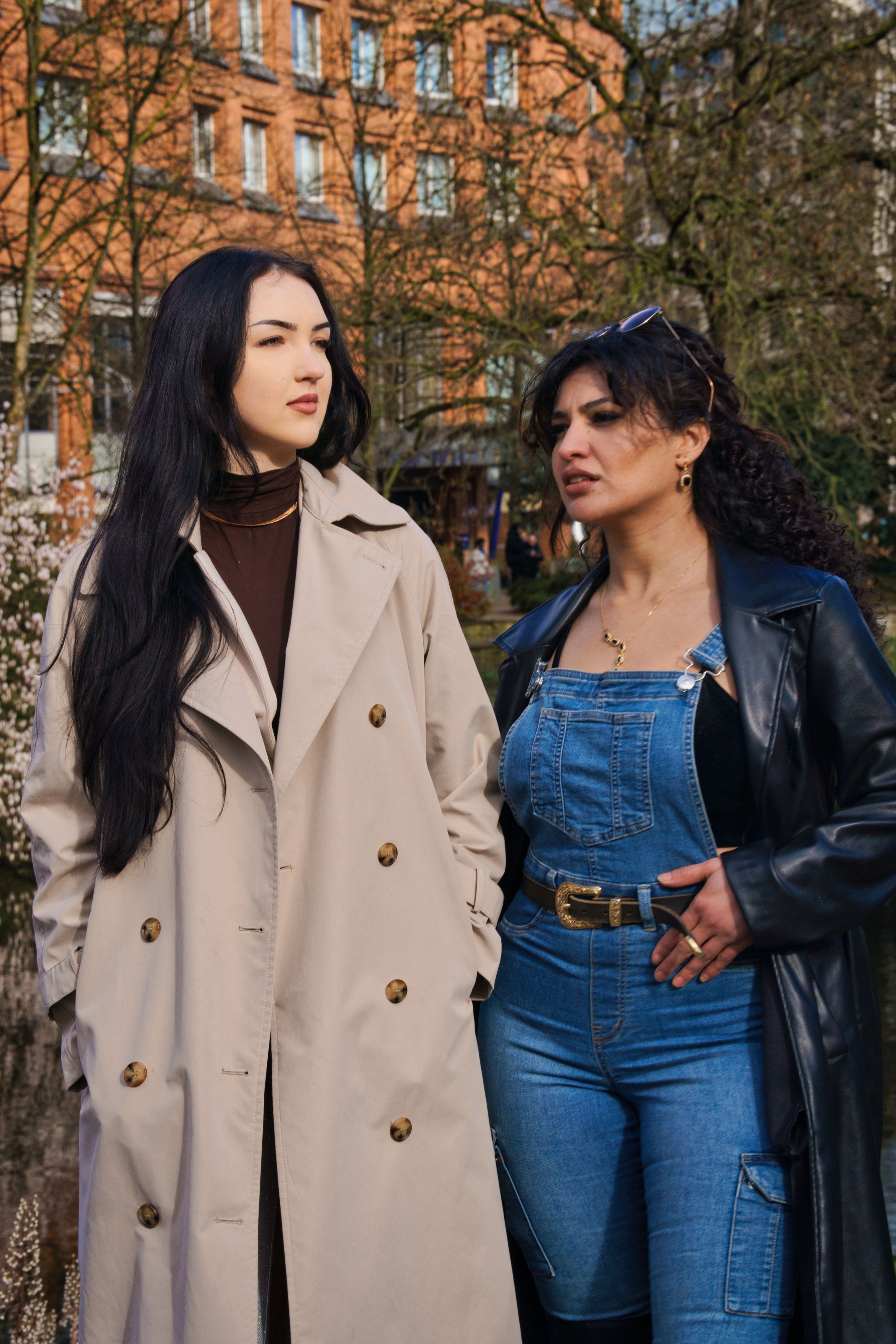 Two Women in Stylish Outfits Walking Outdoors · Free Stock Photo