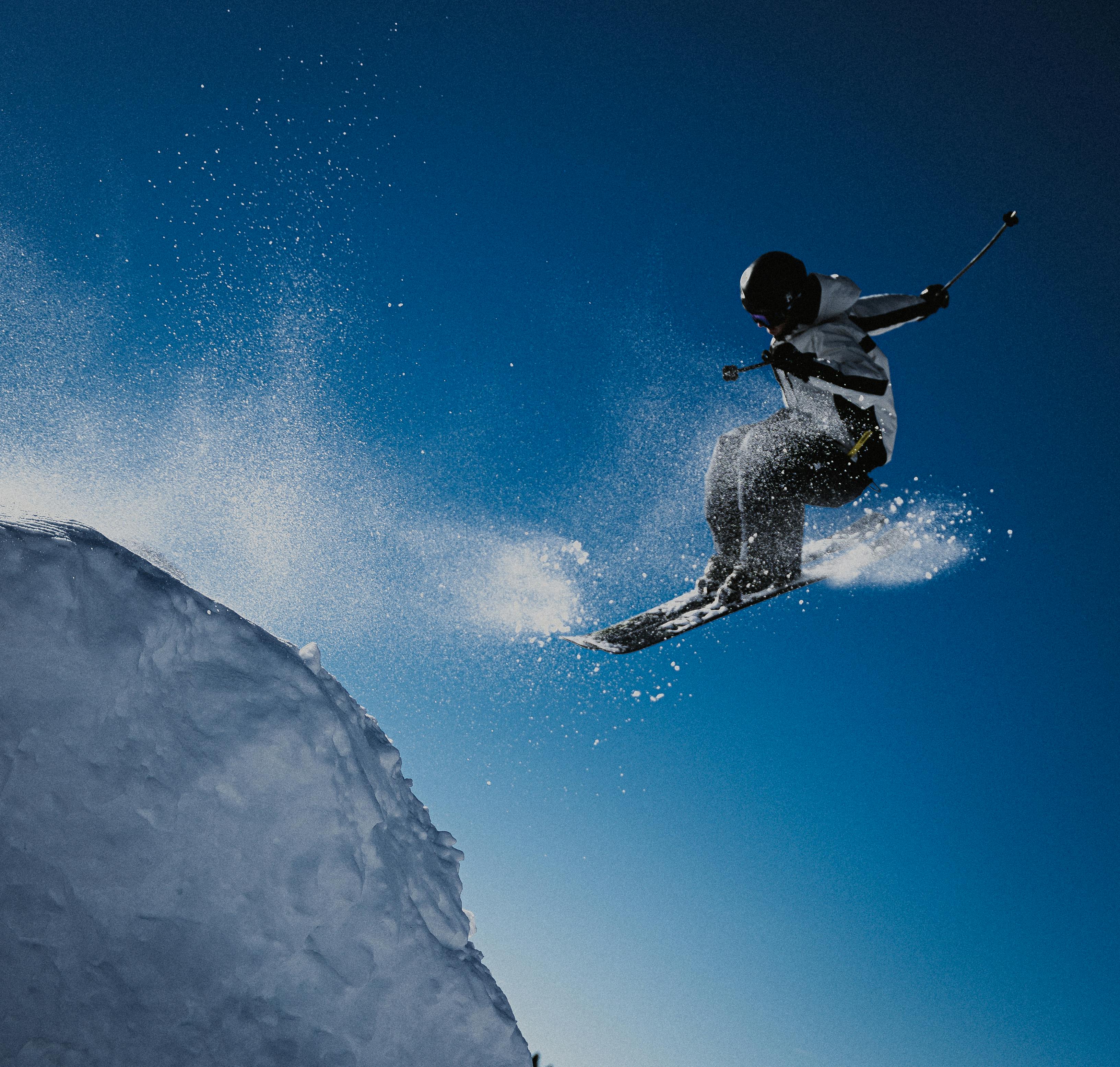 Dynamic shot of a skier performing an aerial jump in Le Grand-Bornand, France.