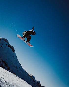 Dynamic snowboarding action in Le Grand-Bornand, France - thrilling winter sport.