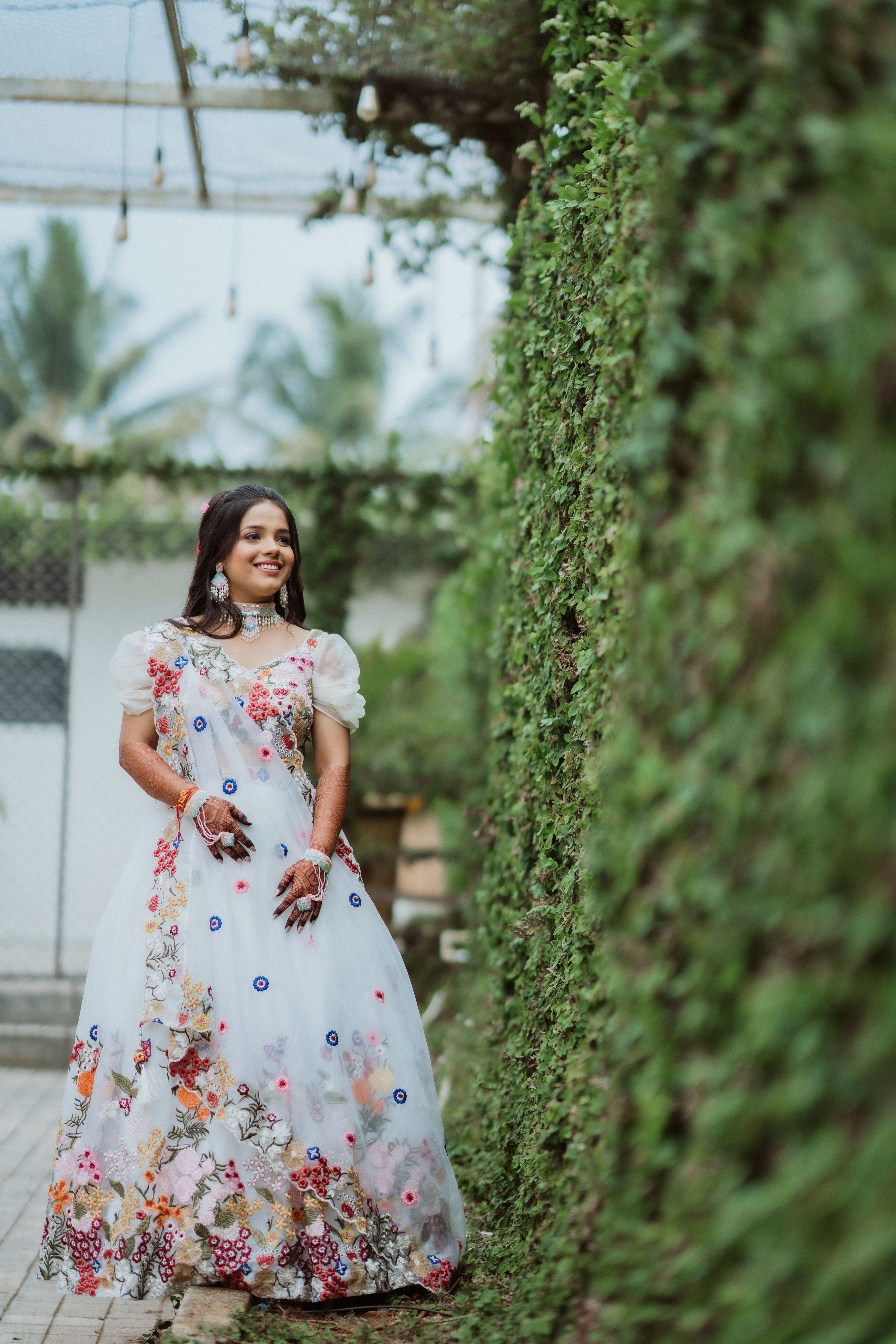 Elegant Woman in Floral Dress Smiling Outdoors · Free Stock Photo