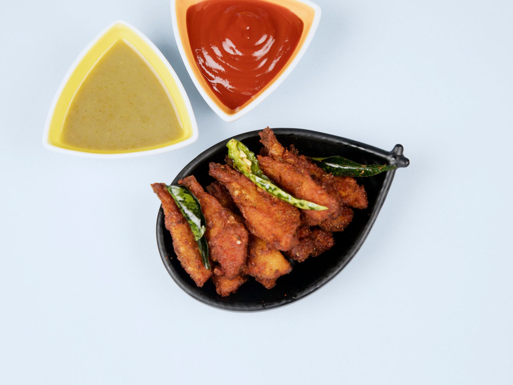 Golden chicken pot stickers on a plate with dipping sauce