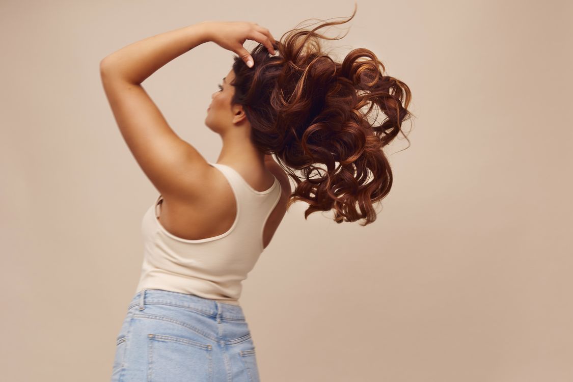 Dynamic Portrait of Woman with Flowing Curly Hair · Free Stock Photo