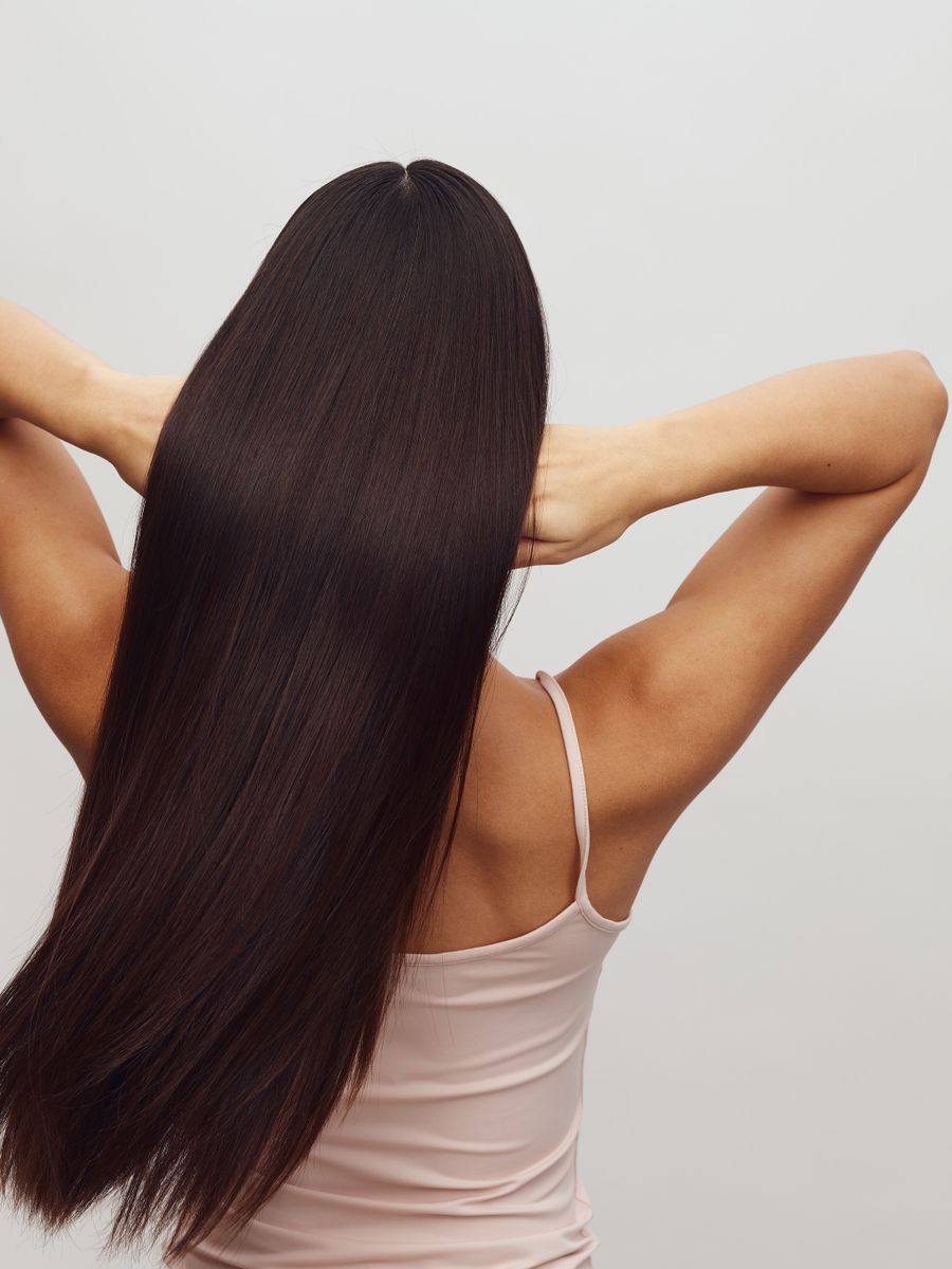 Cabelo castanho escuro alisado e brilhante, visto de costas