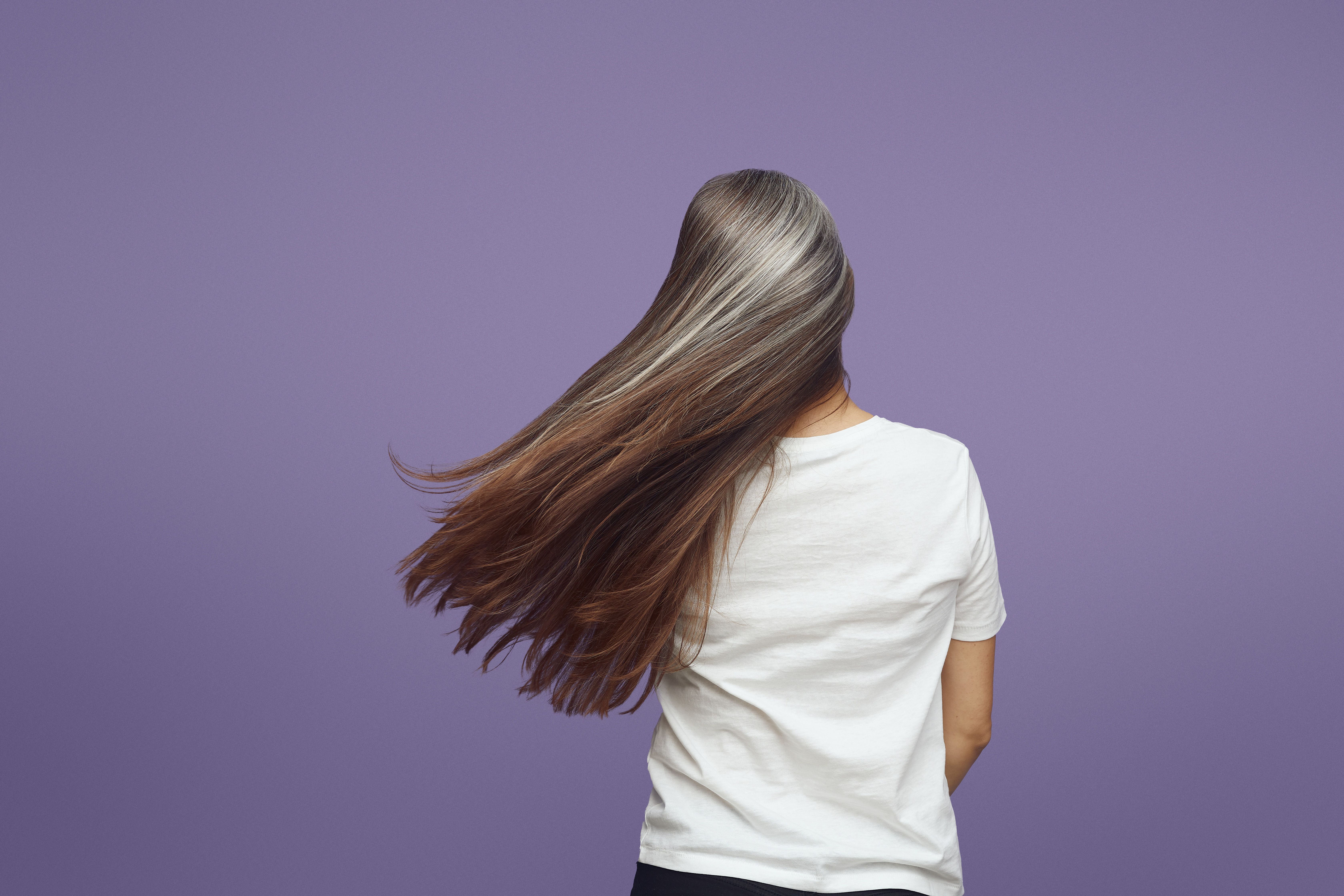 Rear view of a woman with long flowing silver-grey hair
