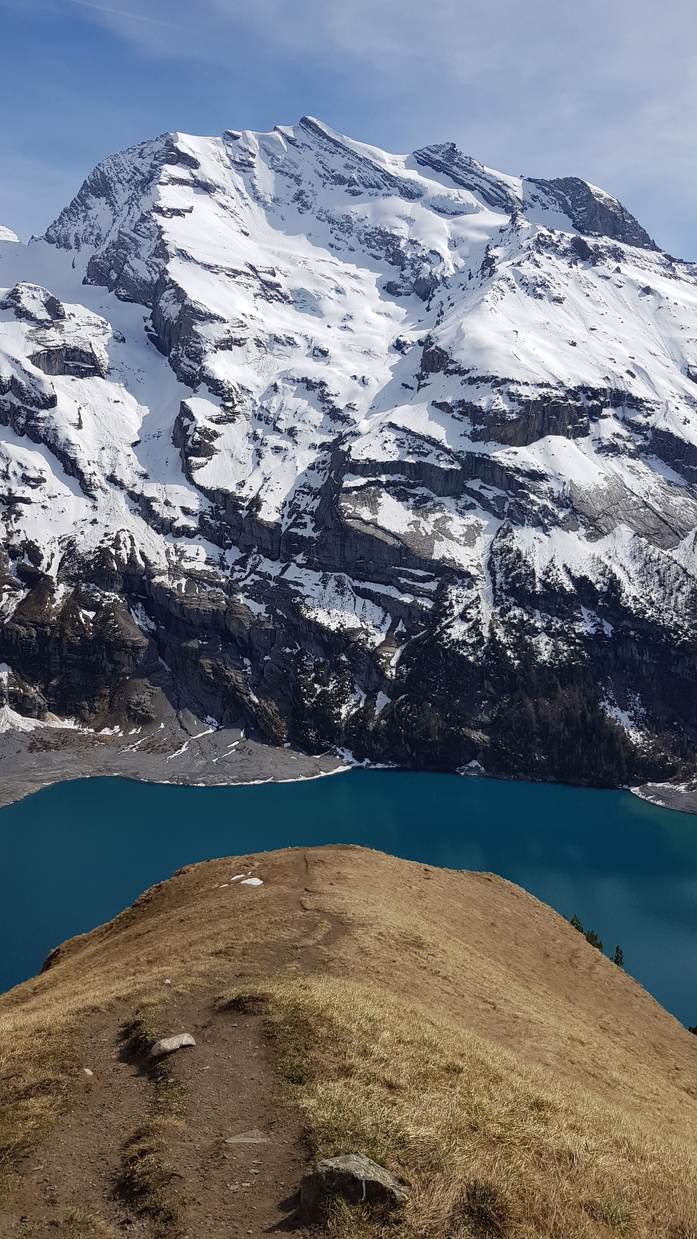 Breathtaking landscape of snow-capped Swiss Alps above Lake Oeschinen near Kandersteg.