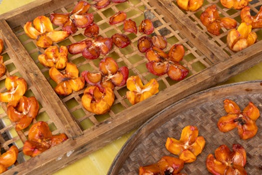 Close-up of sun-dried fruits placed on wooden trays, showcasing natural preservation techniques.