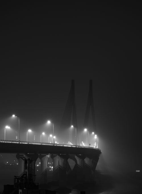 Free Ethereal bridge at night with fog and bright streetlights in a monochrome tone. Stock Photo