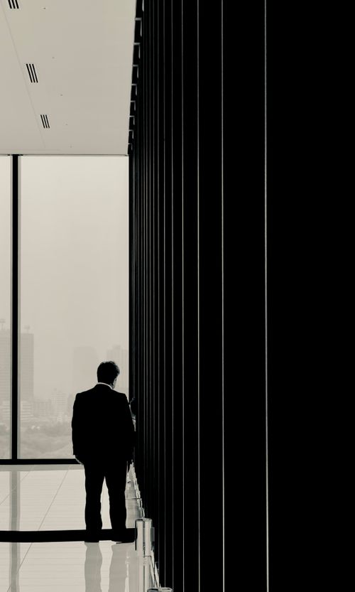 Free Silhouette of a businessman in a modern office with cityscape view in Shibuya, Tokyo. Stock Photo