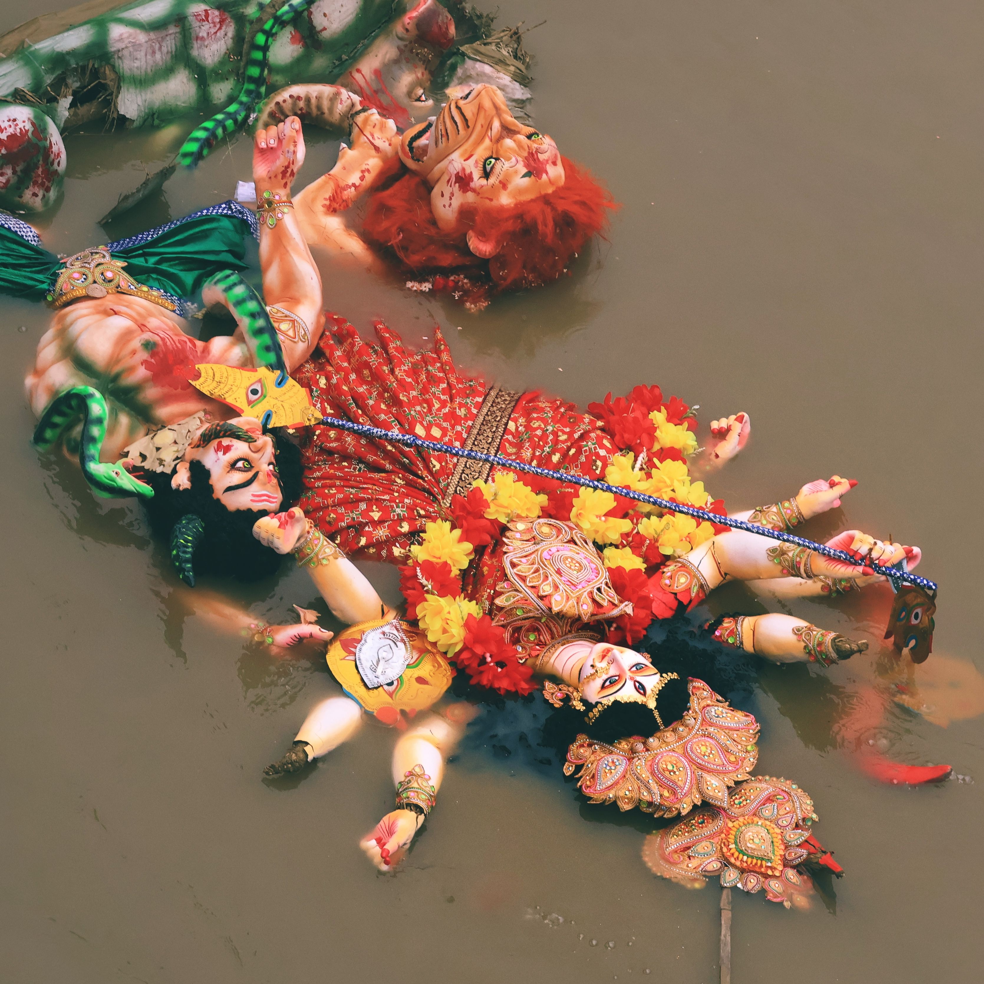 Colorful Hindu Deity Statues in Water Ritual · Free Stock Photo
