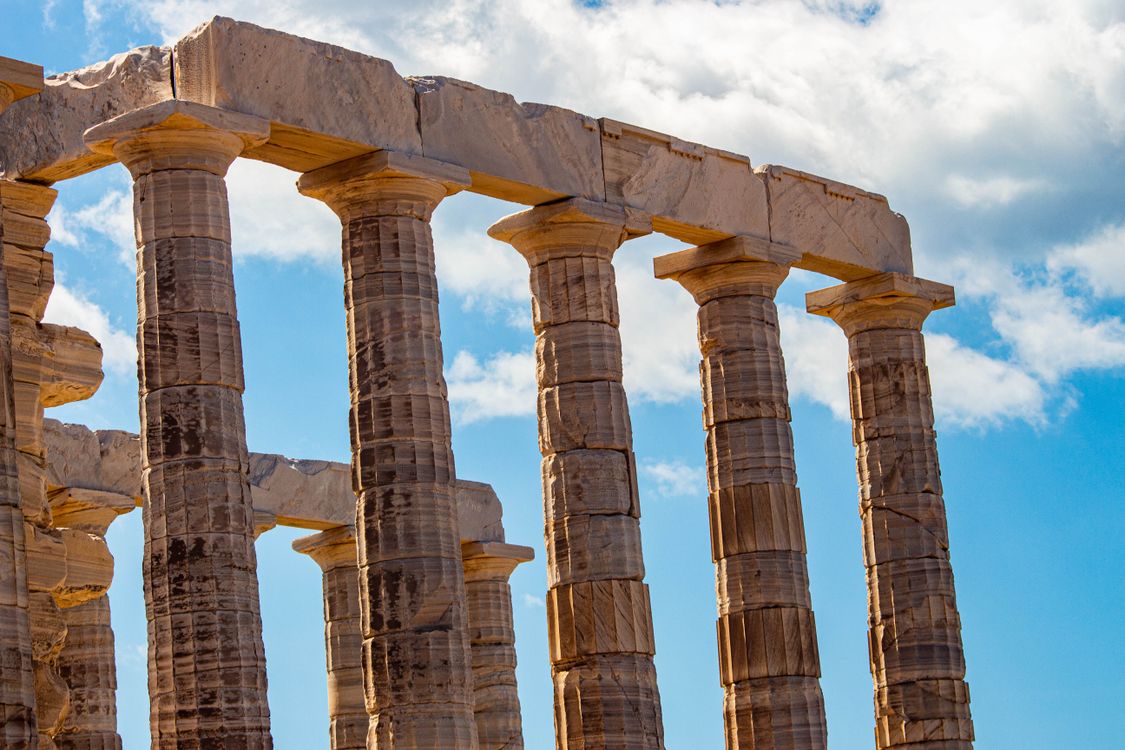 Ancient Greek Temple Columns Against Blue Sky · Free Stock Photo