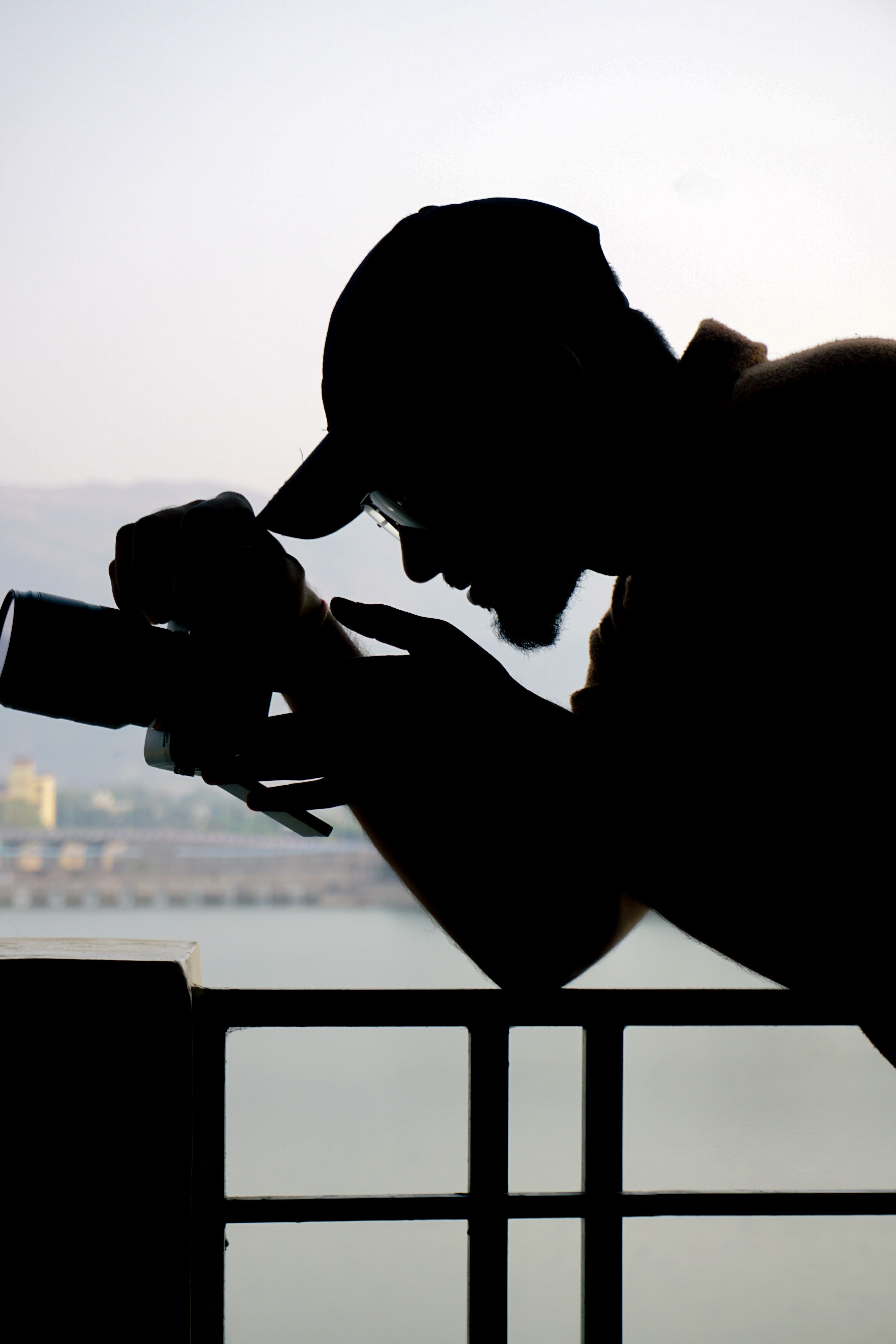 Silhouette of a photographer capturing the scenic view of Ajmer city, Rajasthan, India.