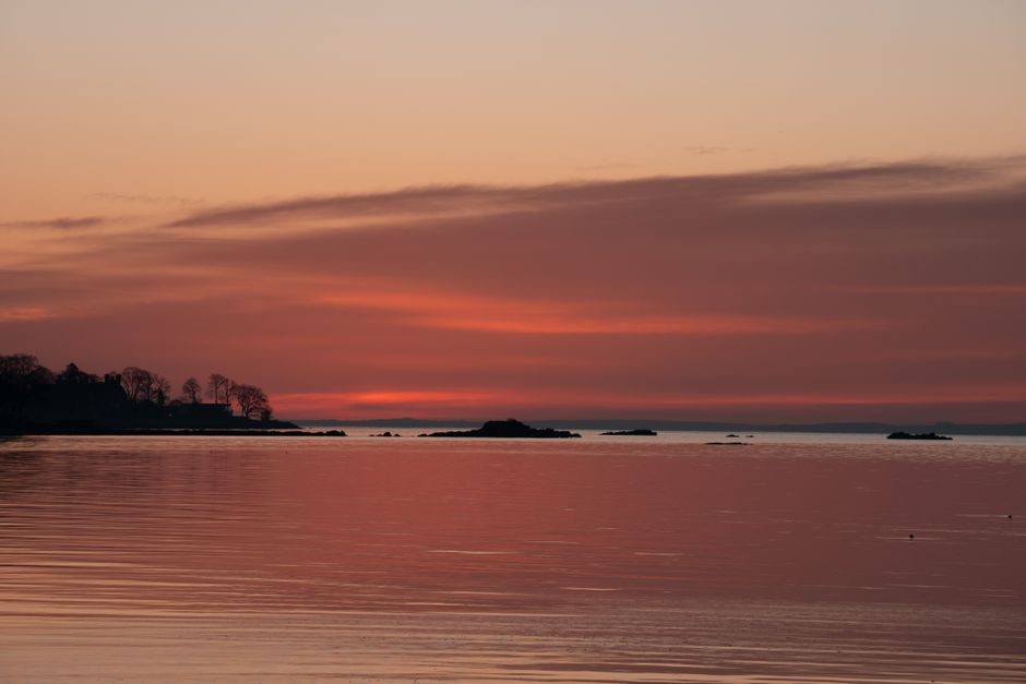 Breathtaking sunrise view over tranquil waters in Stamford, Connecticut, showcasing vibrant pink hues. Breathtaking sunrise view over tranquil waters in Stamford, Connecticut, showcasing vibrant pink hues.