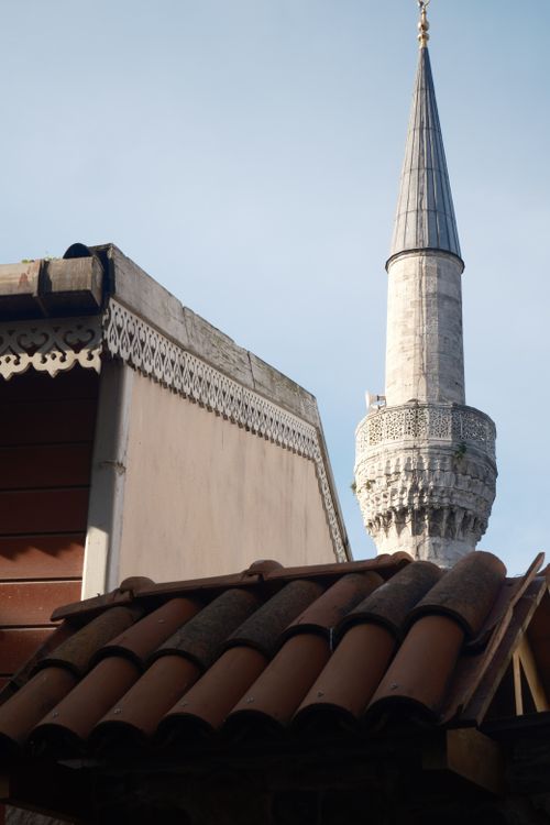 Free View of traditional building with a historical minaret in the background. Stock Photo