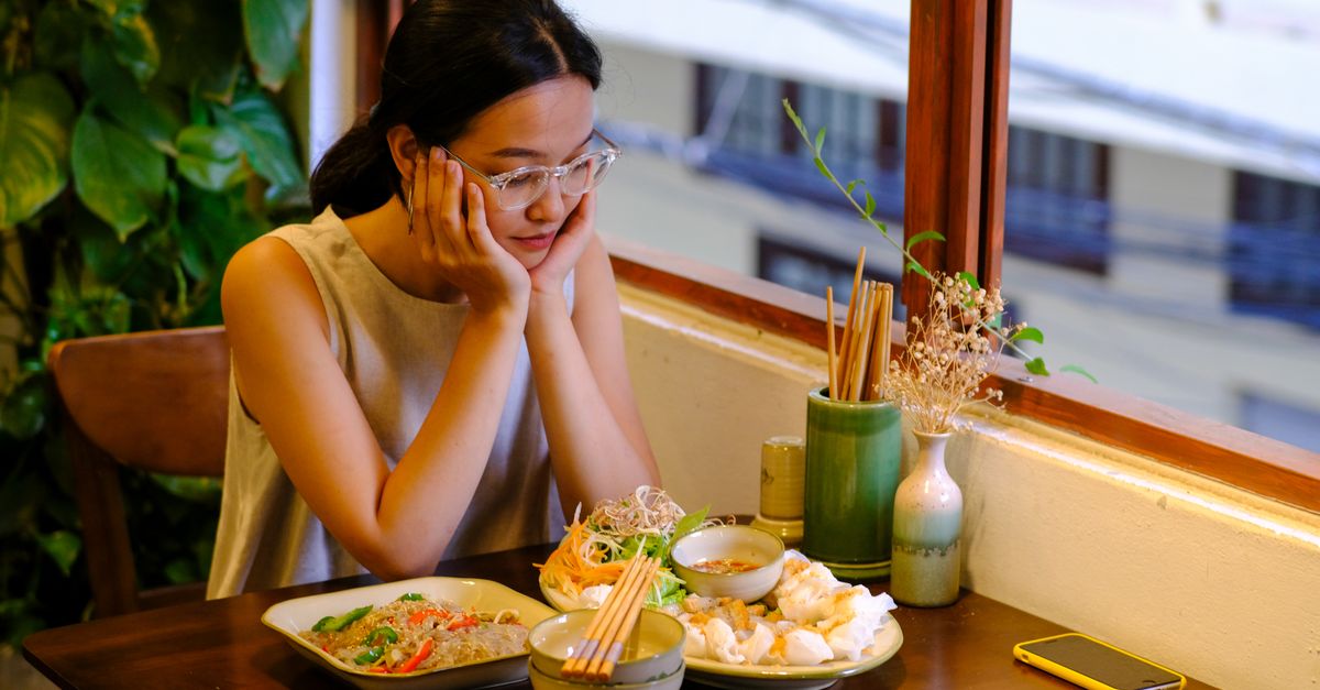 Vietnamese banh xeo crispy pancake with fresh herbs and dipping sauce