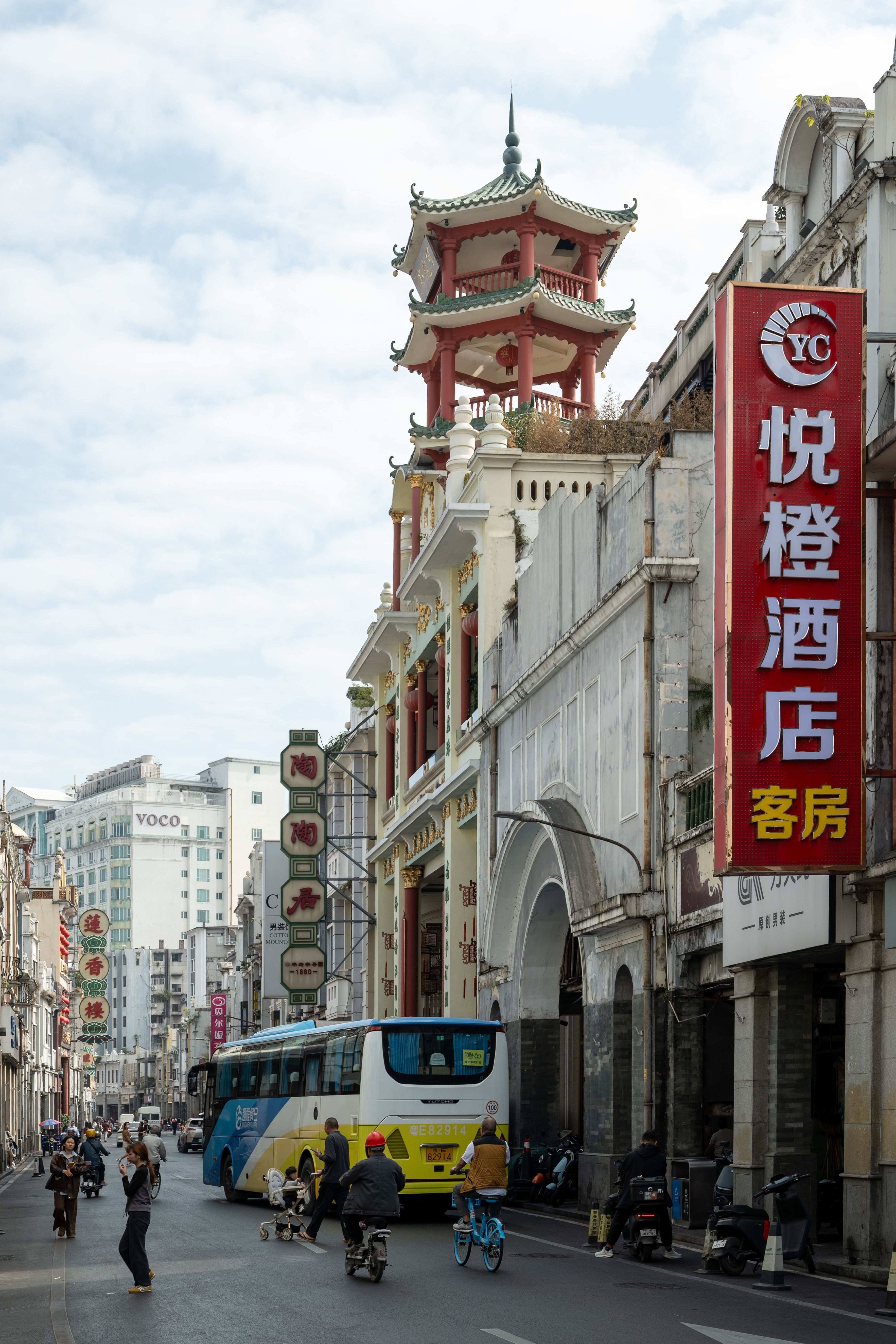 A vibrant street view in Guangzhou showcasing architectural landmarks and busy urban life.