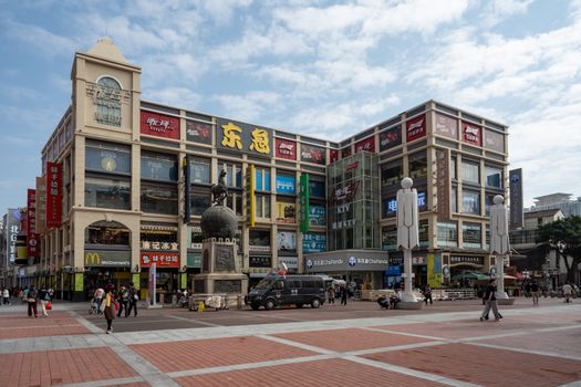 A vibrant commercial square in Guangzhou showcasing modern architecture and lively urban scene.