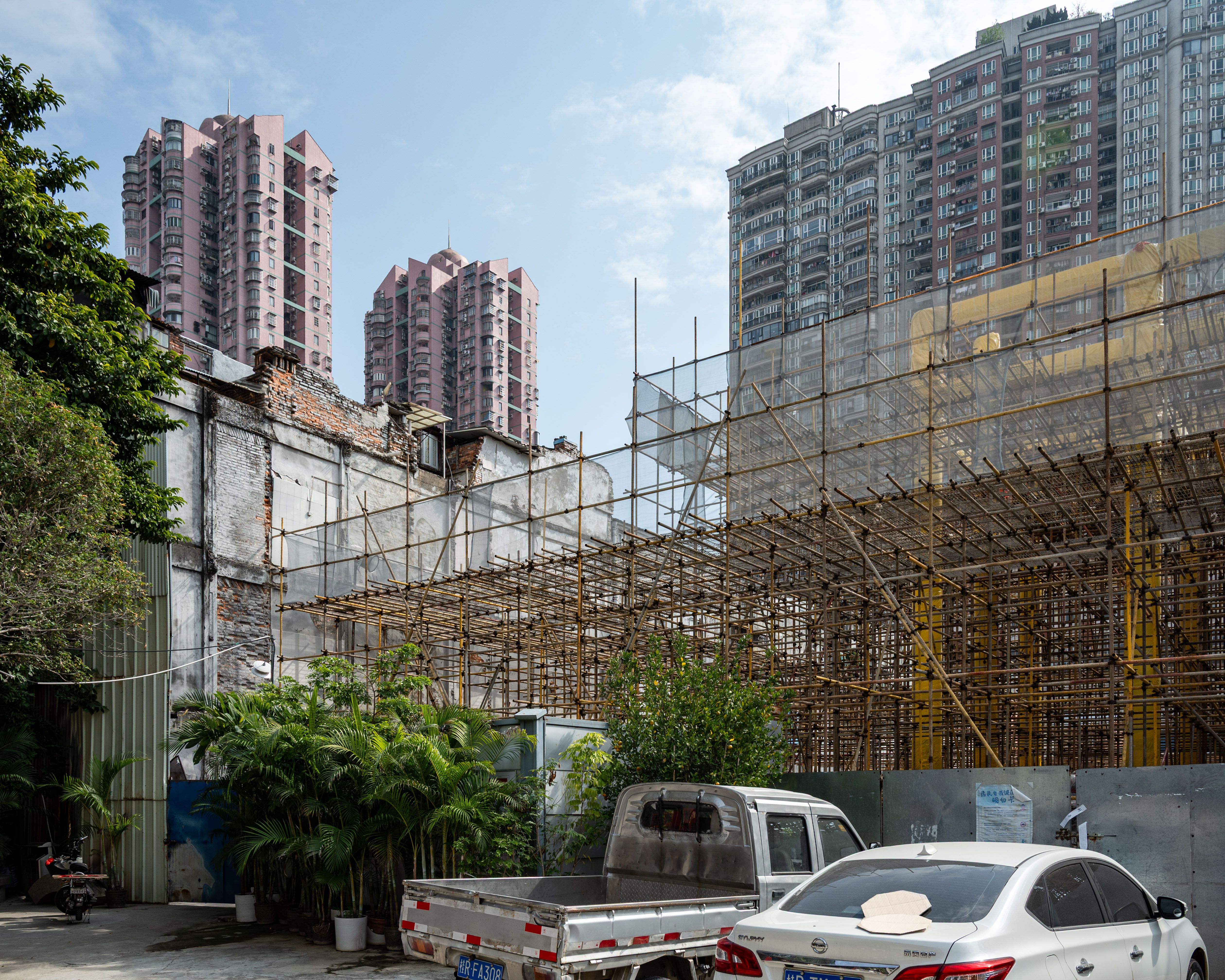A construction site with scaffolding and high-rise buildings in Guangzhou, China.