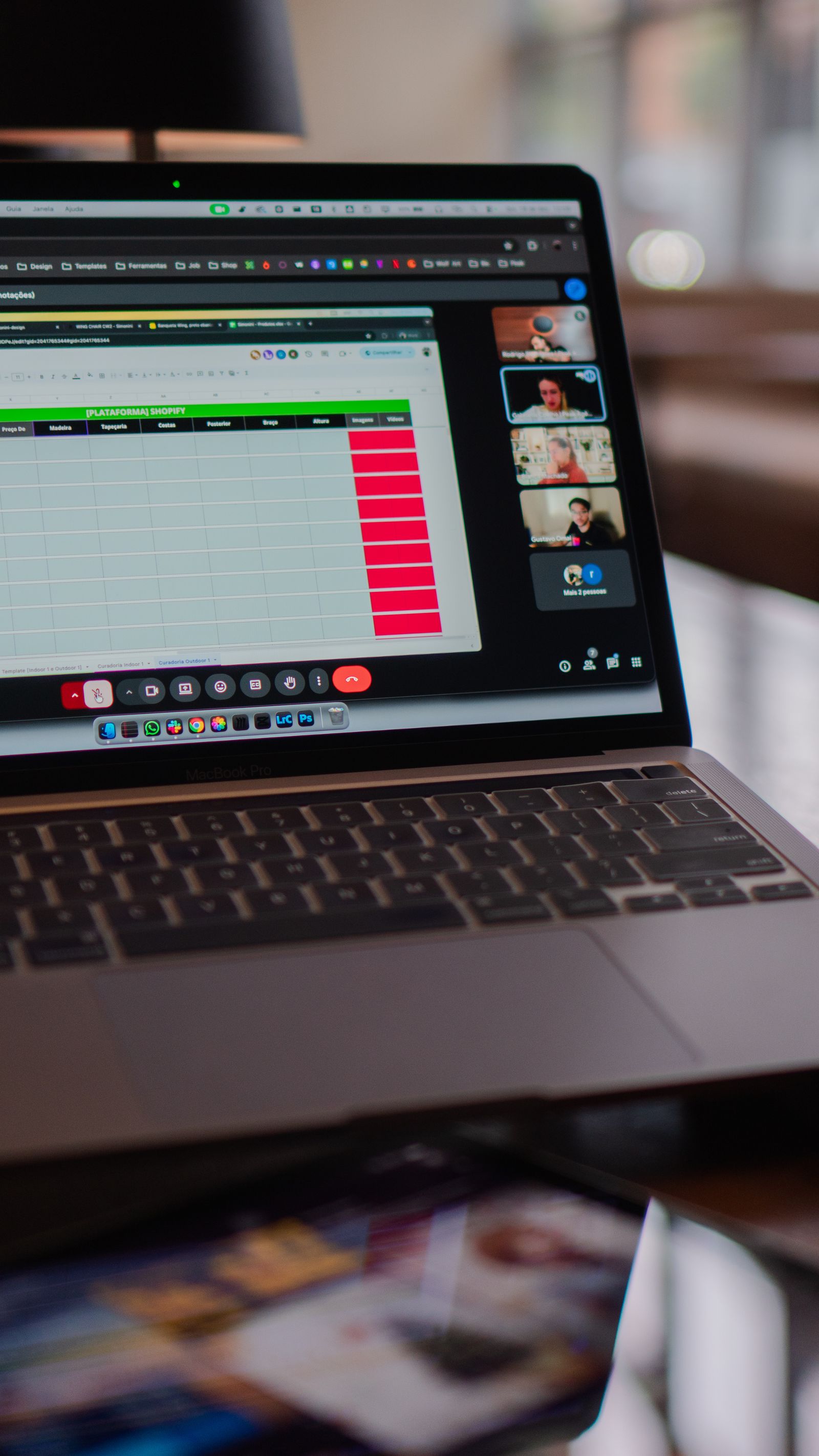 Laptop displaying a remote video meeting in an office