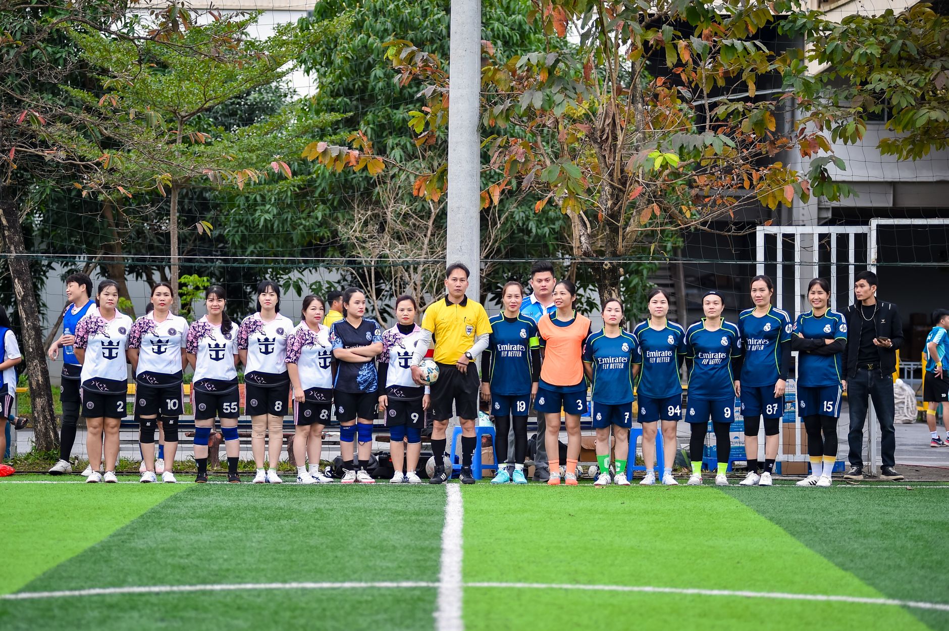 Two women's football teams in Hanoi prepare for a match, showcasing team spirit and sportsmanship.