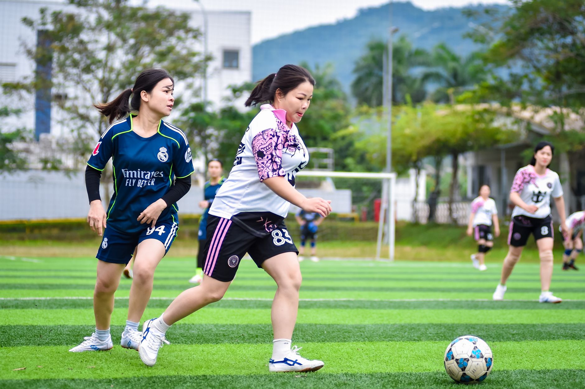 Amateur women's football match showcasing team spirit and sportsmanship in Hà Nội, Vietnam.