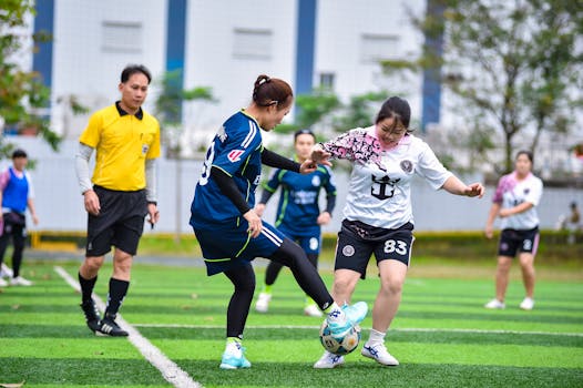Energetic women's football match in Hanoi, showcasing teamwork and athletic spirit.