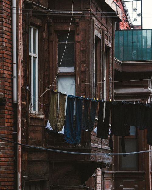 Free Clothes hanging to dry in an old urban neighborhood with vintage architecture. Stock Photo