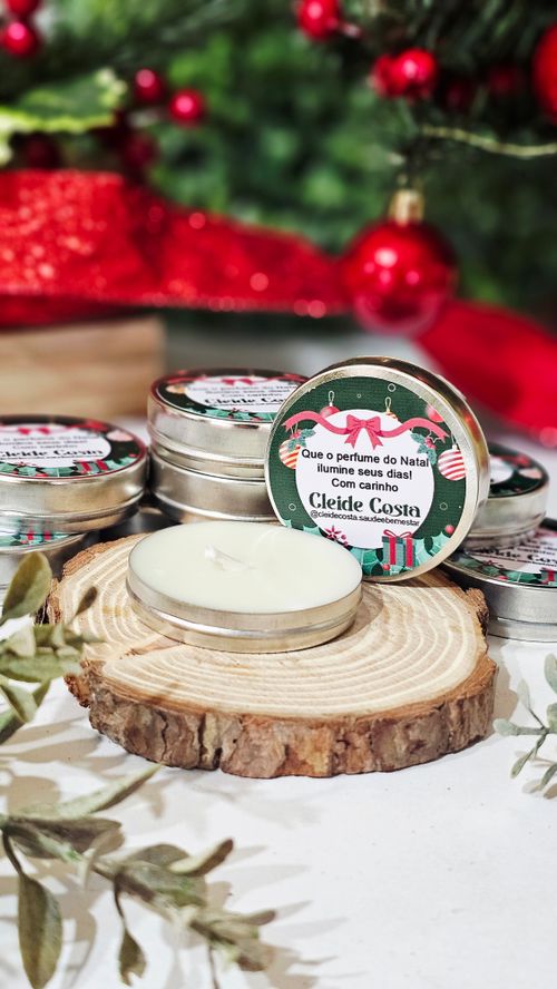 Free A decorative display of Christmas-themed scented candles on a wooden slice. Stock Photo