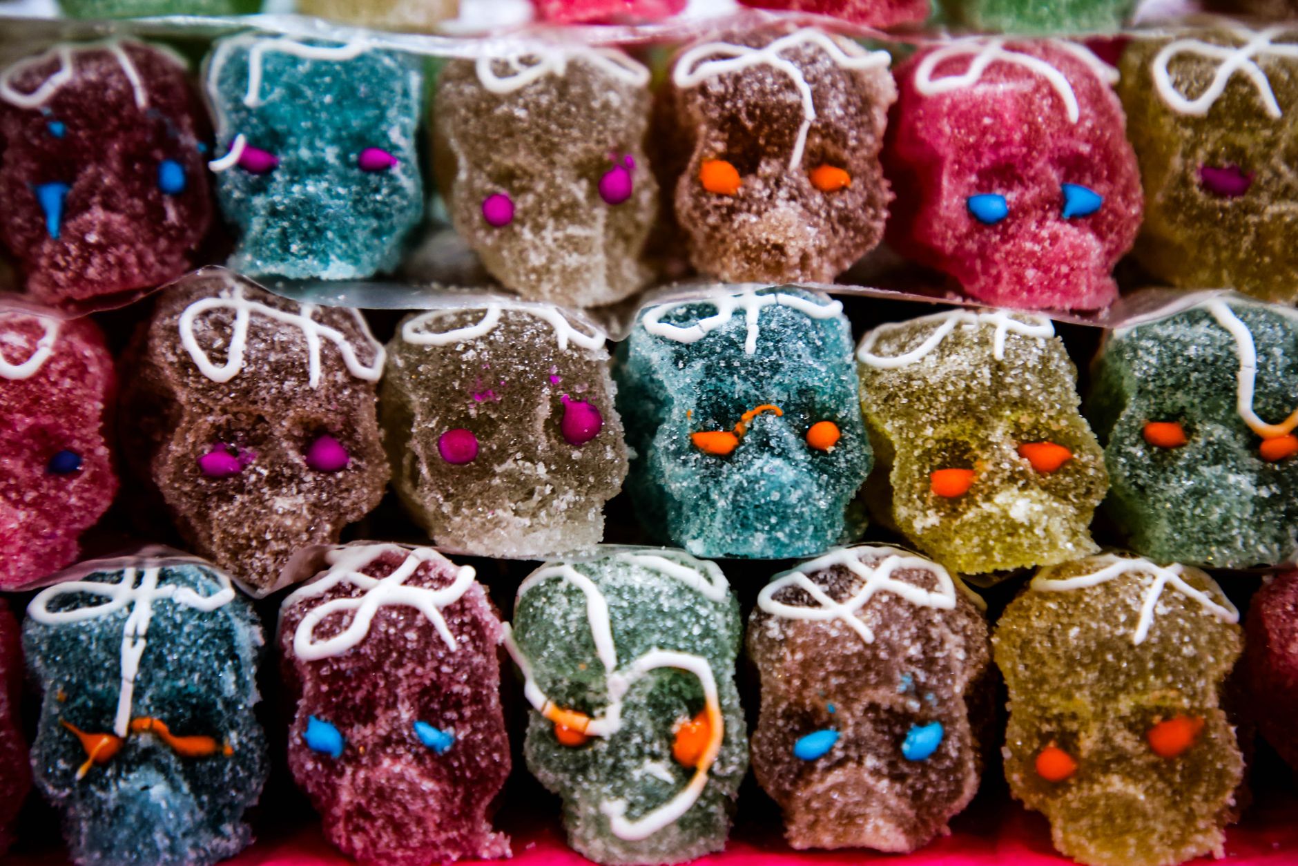 Vibrant sugar skulls in various colors symbolizing Day of the Dead traditions.