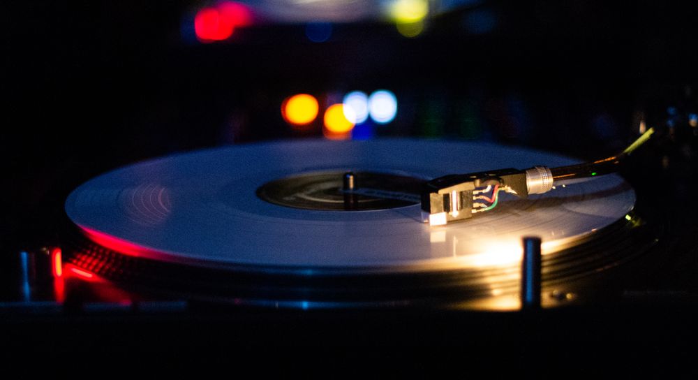 Vinyl record and colorful nightclub lighting