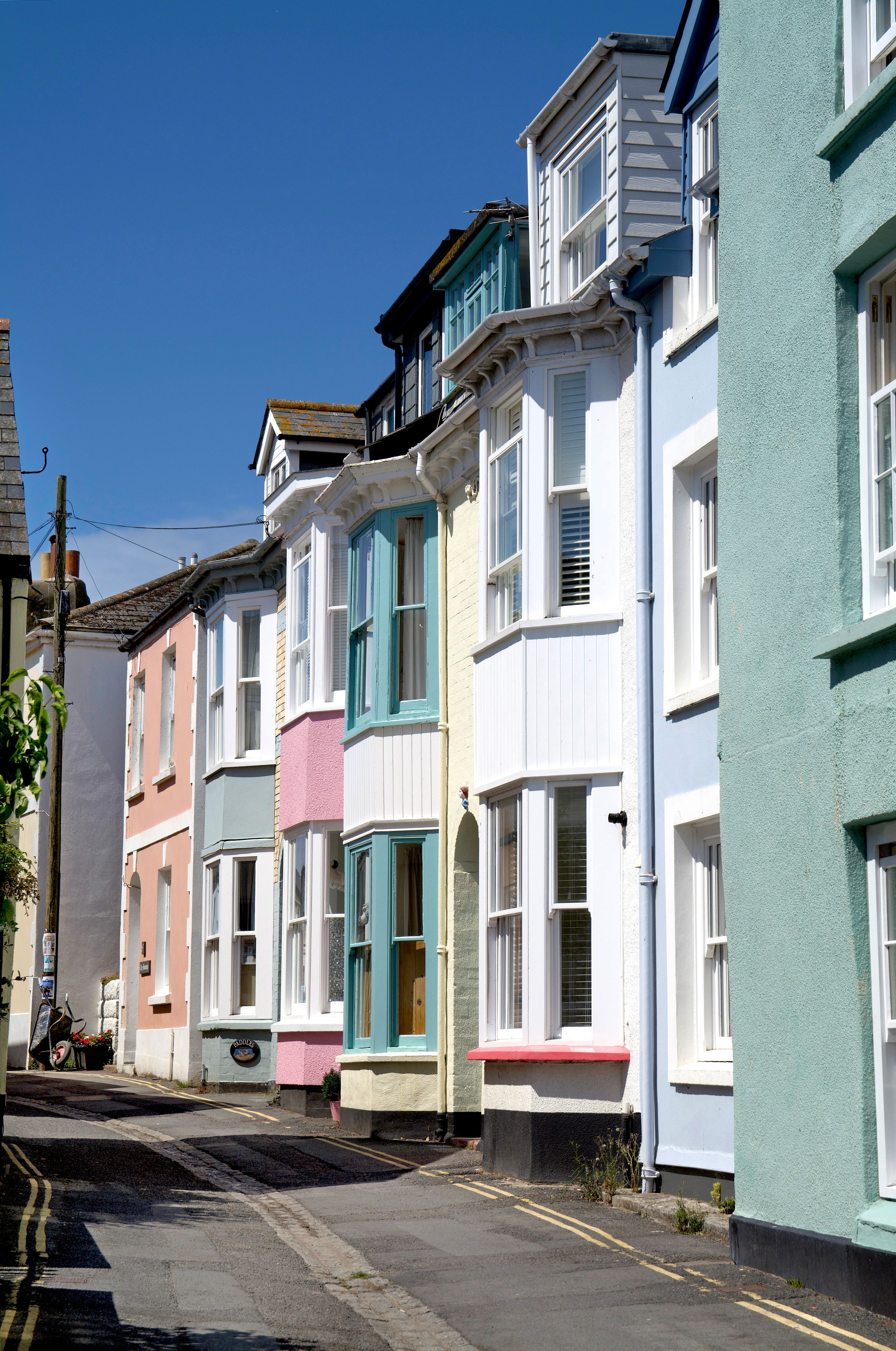 A row of traditional British terraced houses along a residential street